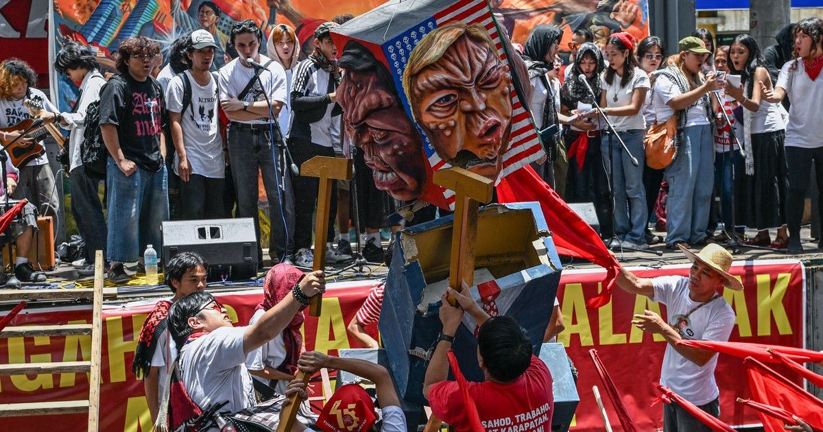 View MAY DAY DAYS pictures around the world as trump large looms